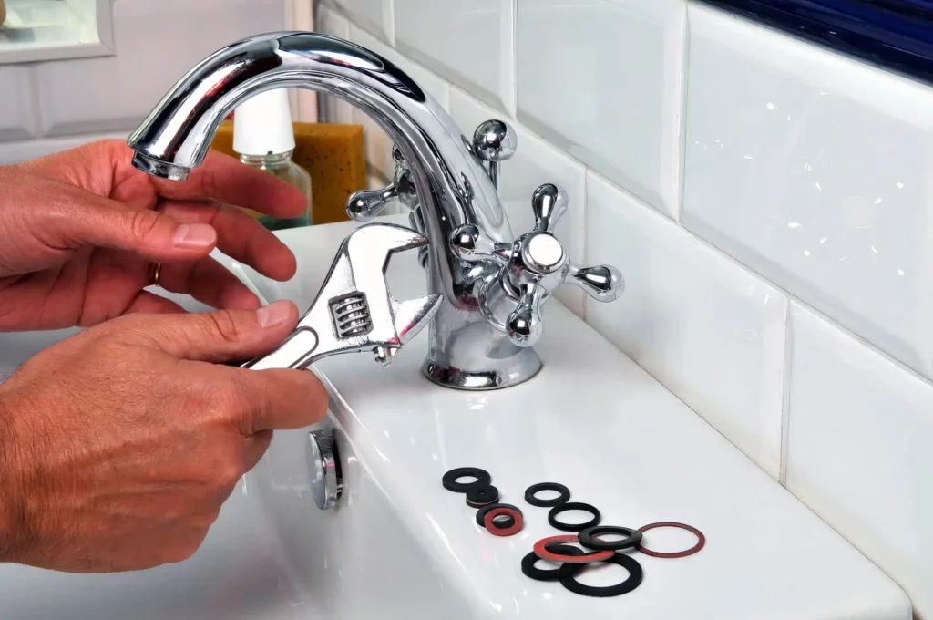 Plumber performing maintenance on a bathroom faucet in Punta Gorda