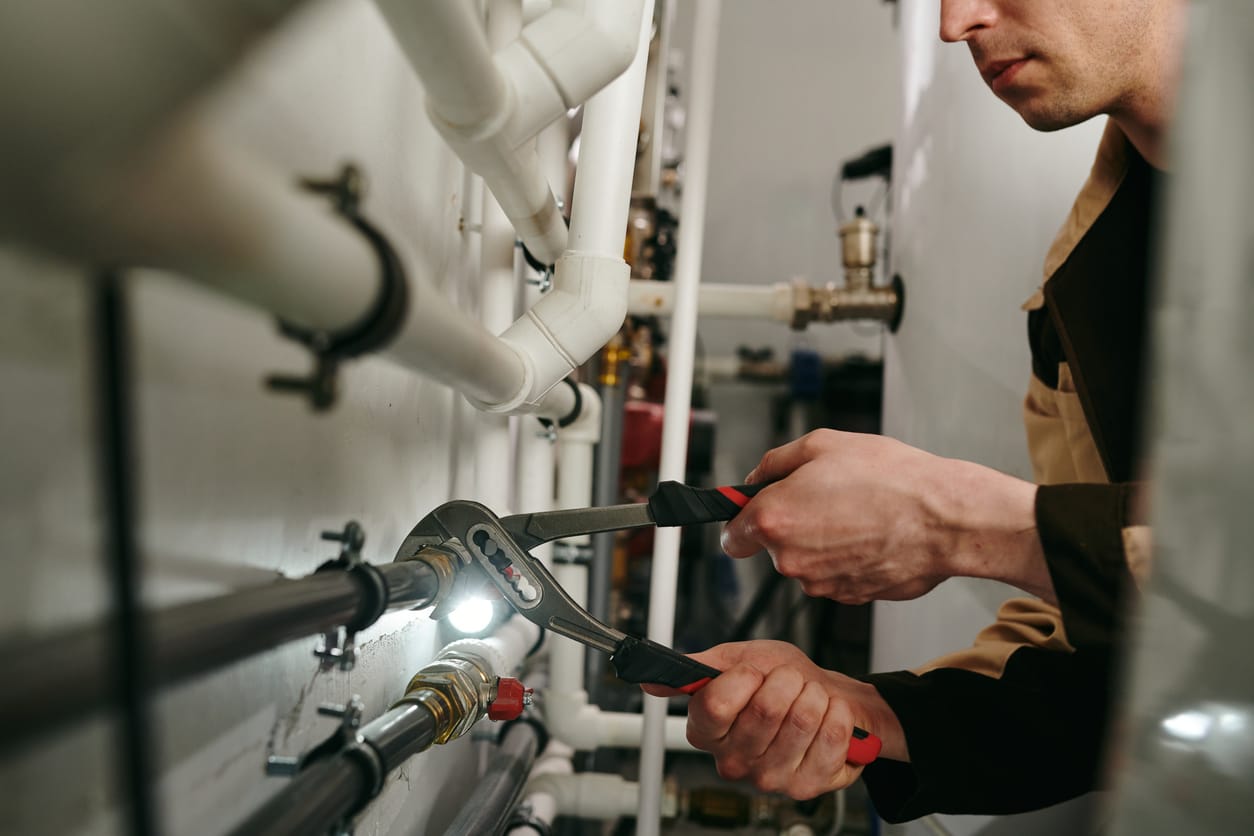 Plumbers maintaining commercial plumbing pipes in Punta Gorda
