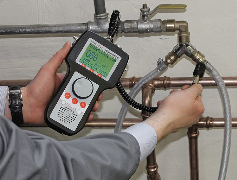 Plumber testing pipes with electronic leak detection equipment in Punta Gorda