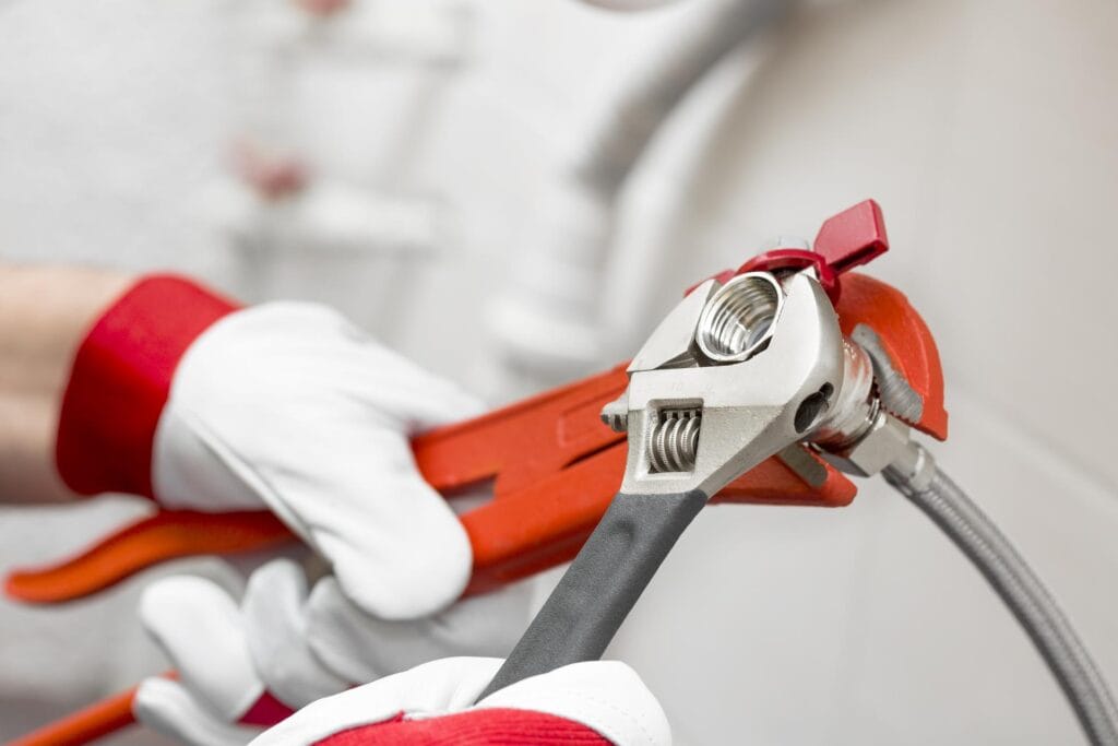 Plumber holding pipe wrenches for an emergency repair in Punta Gorda
