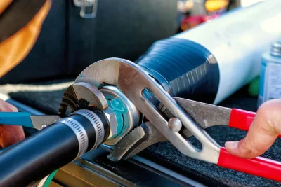 Technician tightening an industrial pipe connection in Punta Gorda