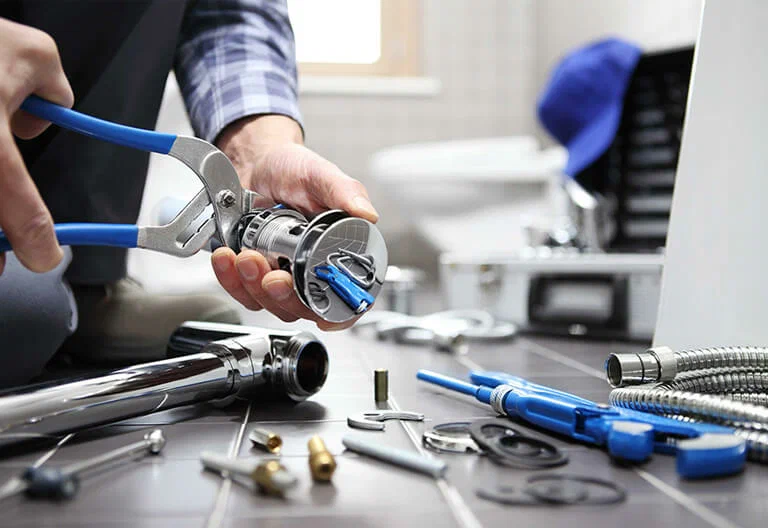 Technician repairing a plumbing fixture with professional tools in Punta Gorda