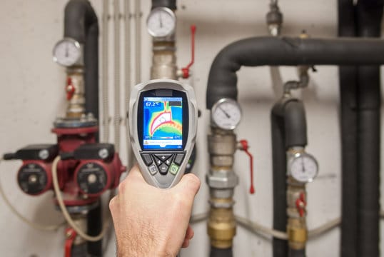 Plumber using a thermal imaging camera to inspect pipes in Punta Gorda