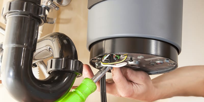 Technician repairing the heating element of a water heater in Punta Gorda