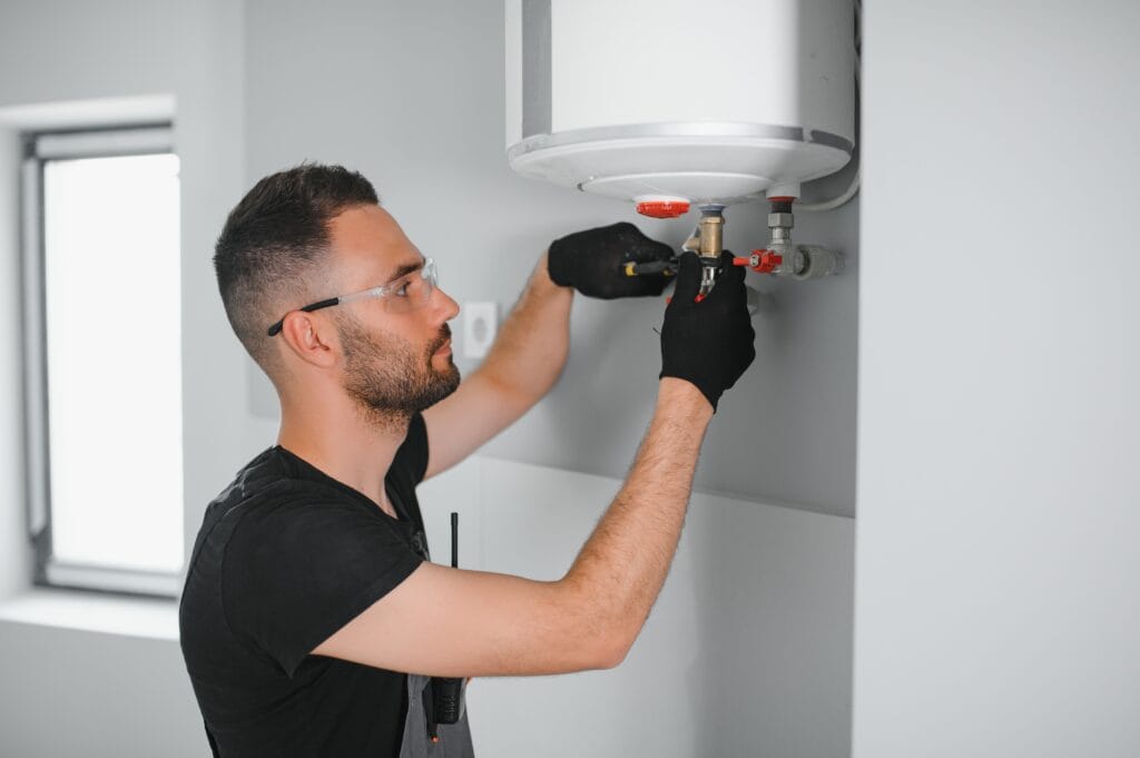 Technician performing water heater maintenance in Punta Gorda