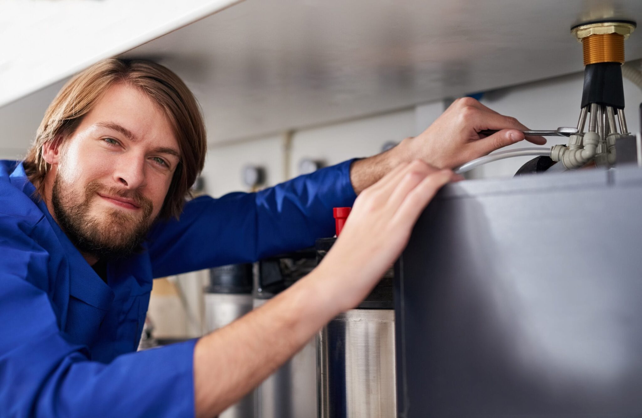 Technician servicing a residential water heater tank in Punta Gorda