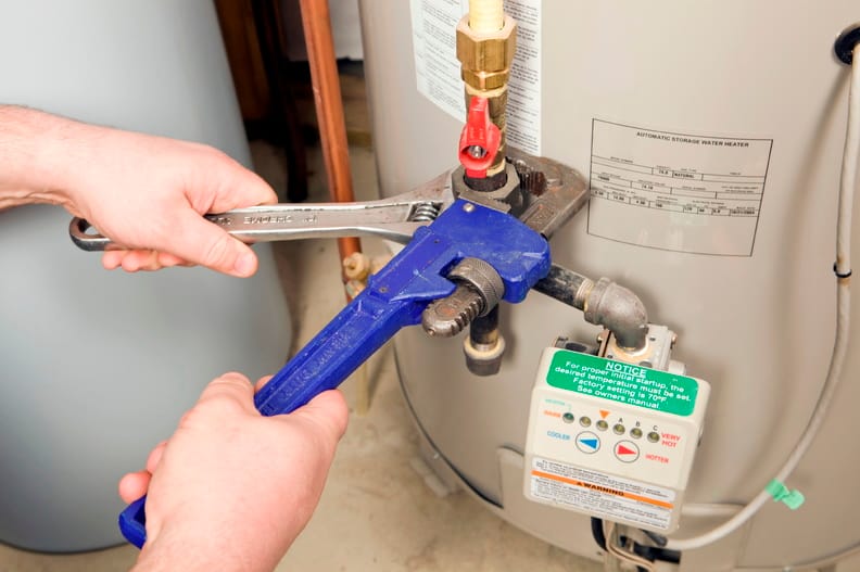 Plumber repairing a water heater valve in Punta Gorda